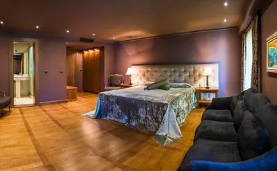 a bedroom with a bed and a couch at Ventura Boutique Hotel in Varna City