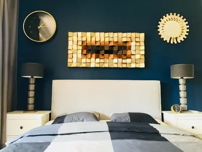 a bedroom with a bed and two lamps and a clock at APARTELLO Modern Apartments - CASA REAL in Sveti Vlas in Sveti Vlas