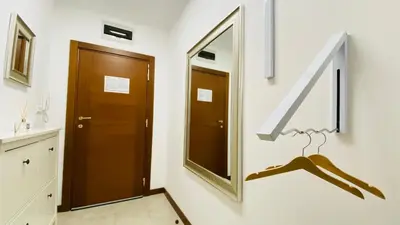 a mirror on a wall next to a door at APARTELLO Modern Apartments - CASA REAL in Sveti Vlas in Sveti Vlas