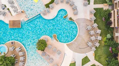 an overhead view of a swimming pool with an elephant statue next to it at HVD Clubhotel Miramar - 24 Hours Ultra All Inclusive & Free Parking in Obzor