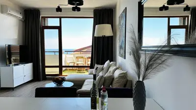 a living room with a couch and a view of the ocean at APARTELLO Modern Apartment - Garden of Eden in Sveti Vlas