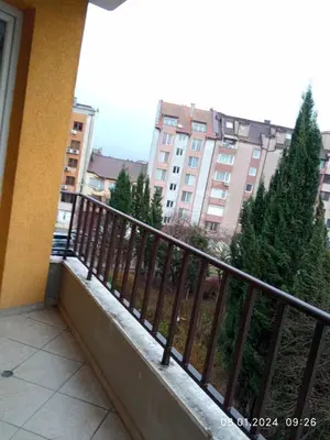 a balcony with a fence and trees and a building at CITY STAY in Varna 2 in Varna City