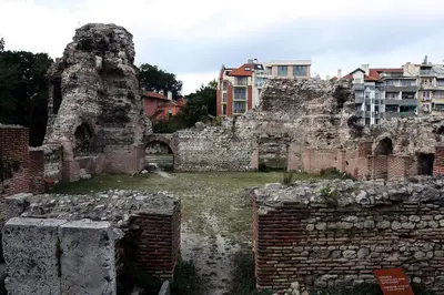 an old stone building with buildings in the background at CITY STAY in Varna 2 in Varna City
