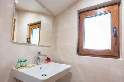 a bathroom with a sink and a mirror at Hotel Albatros New Town in Sozopol