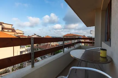a balcony with a table and a view of the city at Hotel Albatros New Town in Sozopol