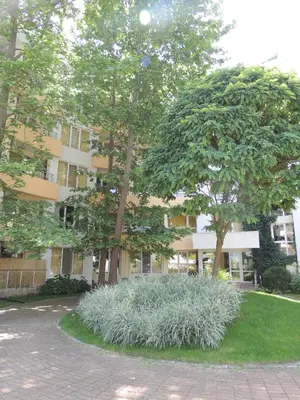 a building with two trees in front of it at Niko Apartments in Sunny Beach
