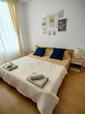 a bedroom with two beds with towels on them at Niko Apartments in Sunny Beach