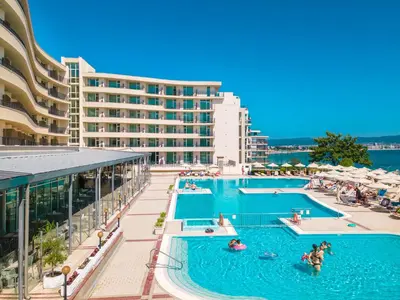 a resort swimming pool with a large building in the background at Festa Panorama Hotel in Nesebar