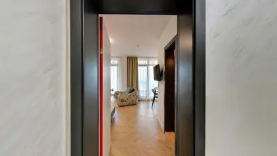 a hallway with a door leading to a living room at Family Hotel LAXO in Obzor
