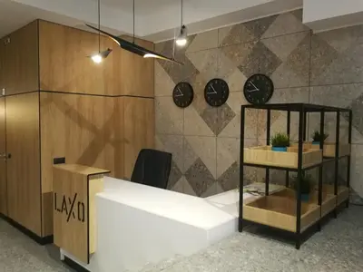 an office with a desk and clocks on the wall at Family Hotel LAXO in Obzor
