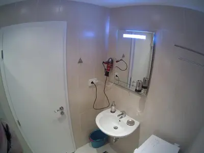 a bathroom with a sink and a shower with a mirror at Aivazovsky Park Anchialos H14 in Pomorie