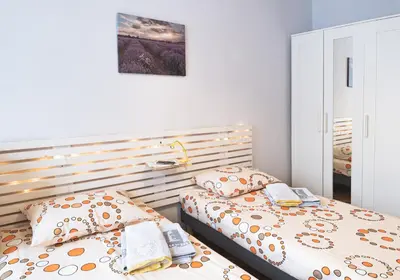 two twin beds in a bedroom with at Photo Art apartment in Burgas City