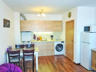 a kitchen with a table and chairs and a refrigerator at Byala Apartments BSR 7 in Byala