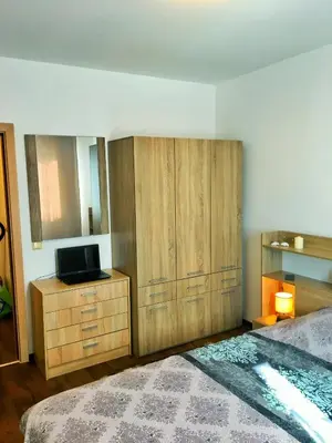 a bedroom with a bed and a dresser with a television at Byala Apartments BSR 7 in Byala