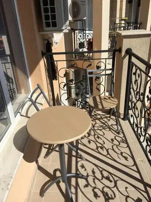 a table and two chairs on a balcony at Byala Apartments BSR 7 in Byala