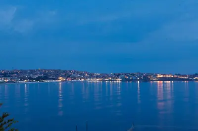 a view of a large body of water at night at Apartments 