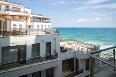 a view of the ocean from the balcony of a building at By The Cliffs apartments in Byala