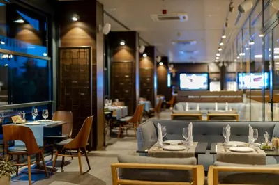 a restaurant with tables and chairs and a dining room at Hotel Bulgaria in Burgas City