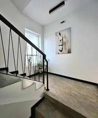 a staircase with a painting of a horse on the wall at GG Garden Deluxe in Chernomorets