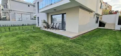 a large white house with a yard with green grass at GG Garden Deluxe in Chernomorets