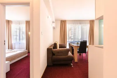 a hotel room with a table and a chair at Guest House Theona in Obzor
