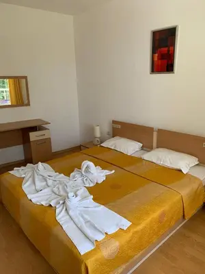 a bedroom with two beds with white towels on them at MNG Holiday Yassen Apartments in Sunny Beach