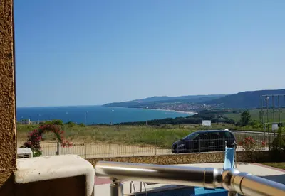 a car parked on a balcony with a view of the water at Apartments Paskalina in Byala