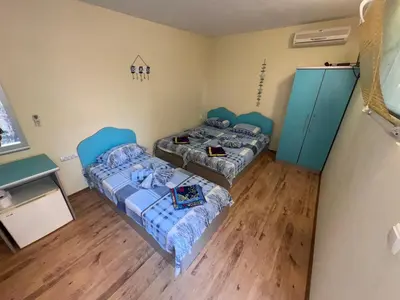 two beds in a room with blue cabinets at Villa SUN in Kiten