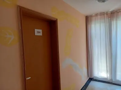 a room with a door with a sign on the wall at хотел Централ in Sozopol