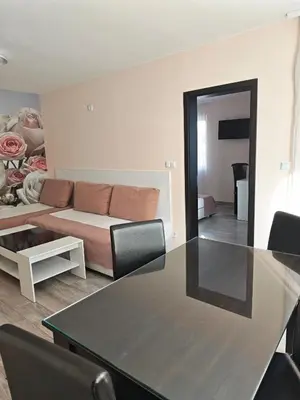 a living room with a table and a couch at Palma in Burgas City