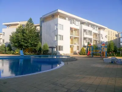 a large apartment building with a pool and a playground at Nessebar Fort Club Apartment 226 in Sunny Beach