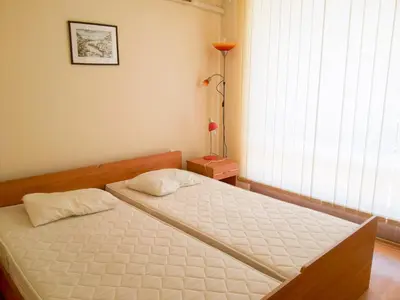 a bedroom with a bed in a room with a window at Nessebar Fort Club Apartment 226 in Sunny Beach