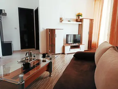 a living room with a couch and a tv at Diamond Palace in Sunny Beach