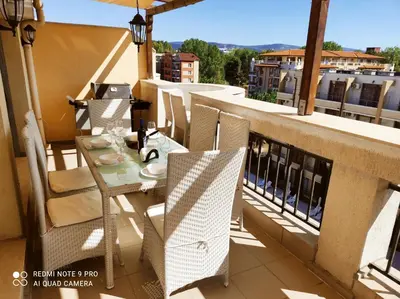 a balcony with a table and chairs on a building at Diamond Palace in Sunny Beach