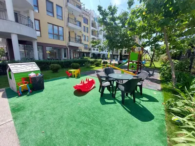 a yard with a playground with a table and chairs at Diamond Palace in Sunny Beach