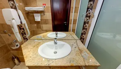 a bathroom with a sink and a shower at Briz Beach Apartments in Sunny Beach