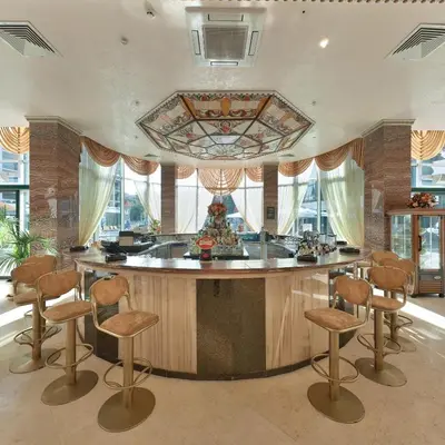 a large kitchen with a center island with stools at Planeta Hotel & Aquapark FREE Beach Access - ULTRA All Inclusive in Sunny Beach