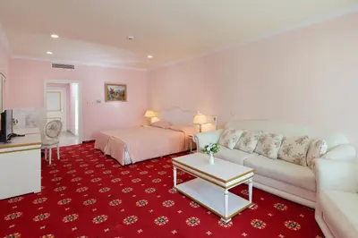 a living room with a bed and a couch at Planeta Hotel & Aquapark FREE Beach Access - ULTRA All Inclusive in Sunny Beach