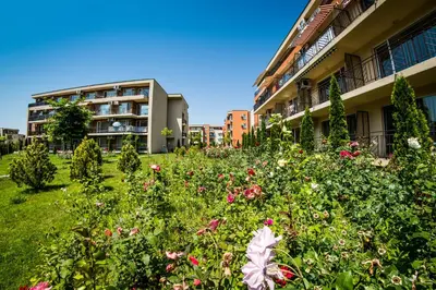 a field of flowers in front of a building at Holiday and Orchid Fort Noks Apartments in Sunny Beach