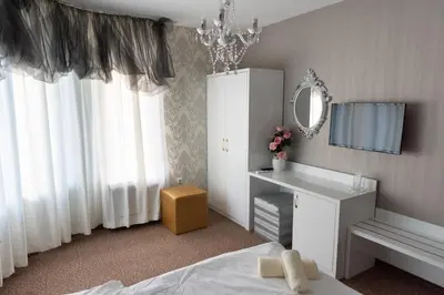 a bedroom with a bed and a vanity and a mirror at Golden House in Varna City