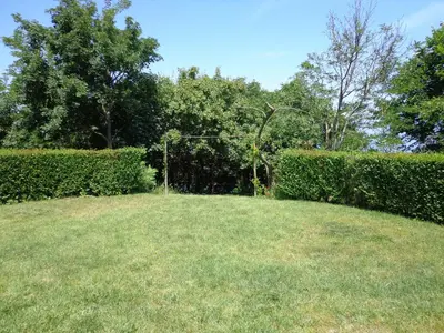 a grassy yard with a hedge and a goal at Villa Via Pontica in Sozopol