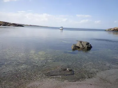 a boat in a large body of water with a rock at Villa Via Pontica in Sozopol