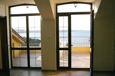 an open door to a balcony with a view of the ocean at Villa Via Pontica in Sozopol