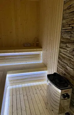 a sauna with a bucket in the middle of a room at Alex Village in Shkorpilovtsi