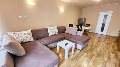 a living room with a couch and a table at Green House Apartment in Burgas City
