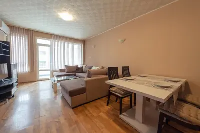 a living room with a couch and a table at Green House Apartment in Burgas City