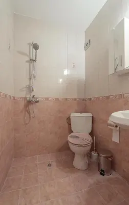a bathroom with a toilet and a sink at Green House Apartment in Burgas City