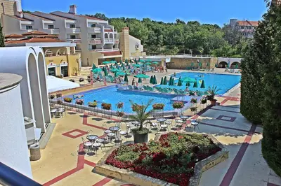 an overhead view of a swimming pool with tables and chairs at Duni Pelican Hotel - All Inclusive in Sozopol
