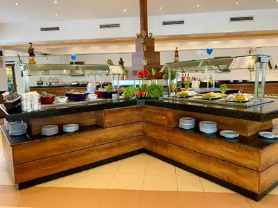a buffet in a restaurant with dishes on display at Duni Belleville - All Inclusive in Sozopol
