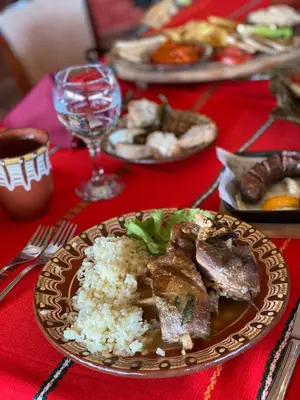 a plate of food with rice and meat on a table at Duni Belleville - All Inclusive in Sozopol